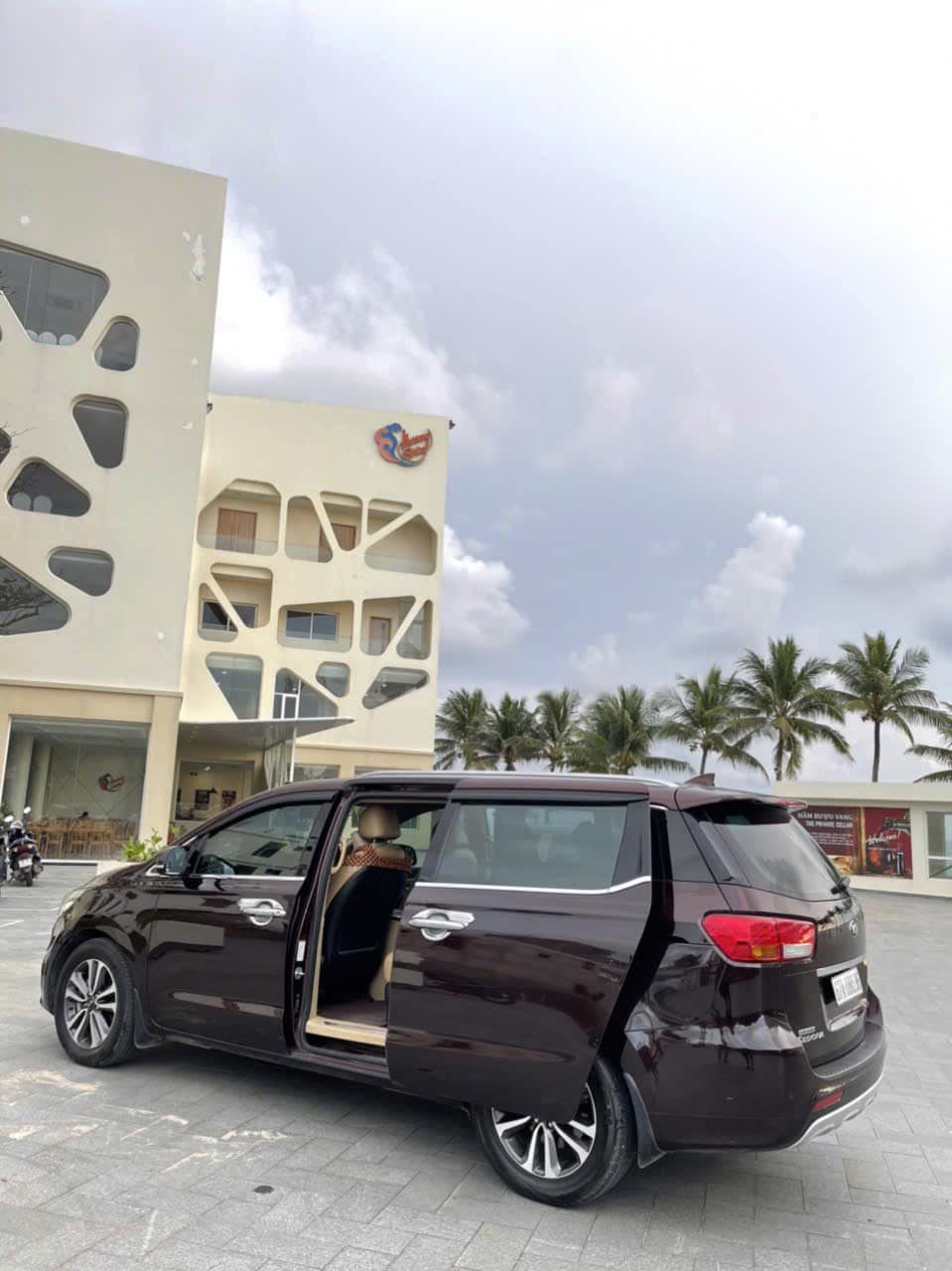 Kia Sedona minivan with door open showing captain's seats